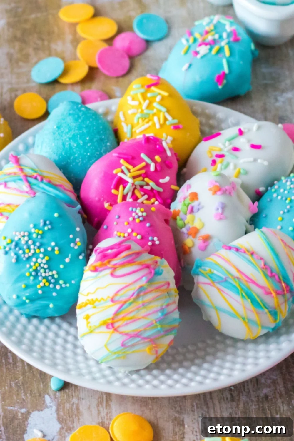 Easter Egg Oreo Truffles on a plate with candy melts around it on table 