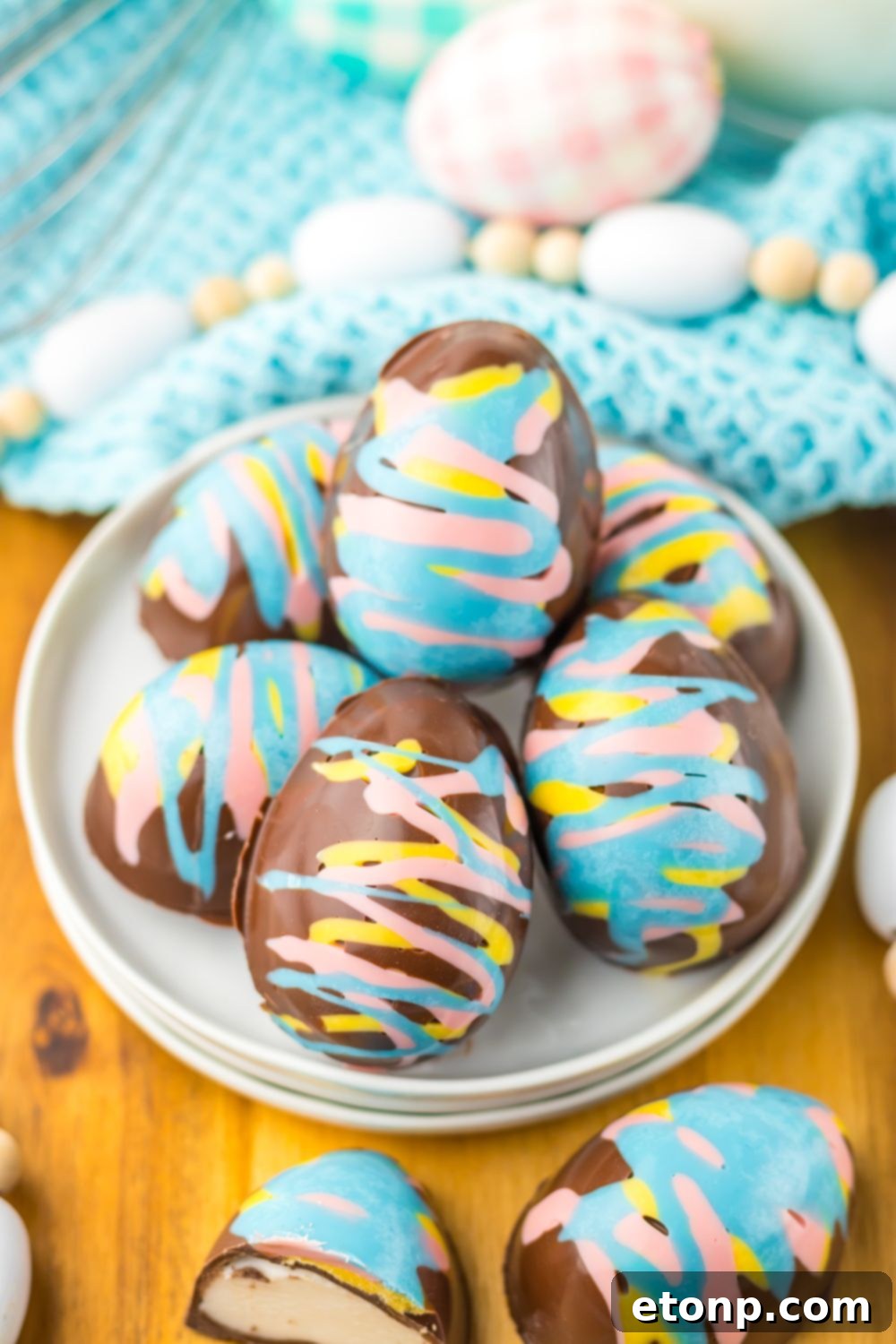 Easter Marshmallow Eggs stacked on a plate and candies around it 