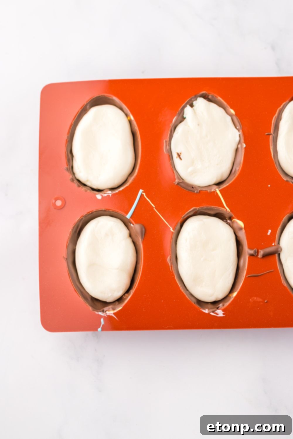 Easter Marshmallow Eggs being assembled in a silicone mold