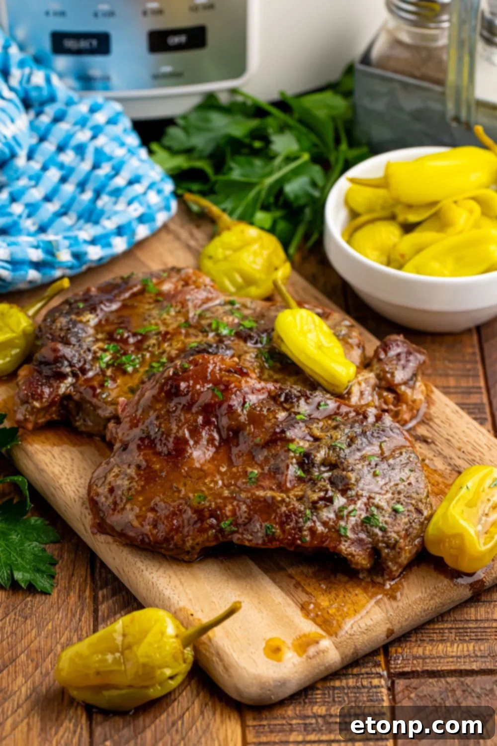 steak au jus on cutting board fromSlow Cooker Mississippi Ribeye Steaks