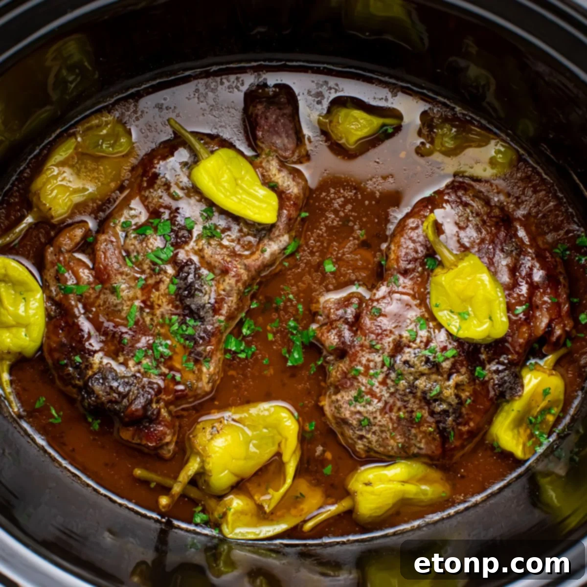 Slow Cooker Mississippi Ribeye Steaks in a slow cooker on table