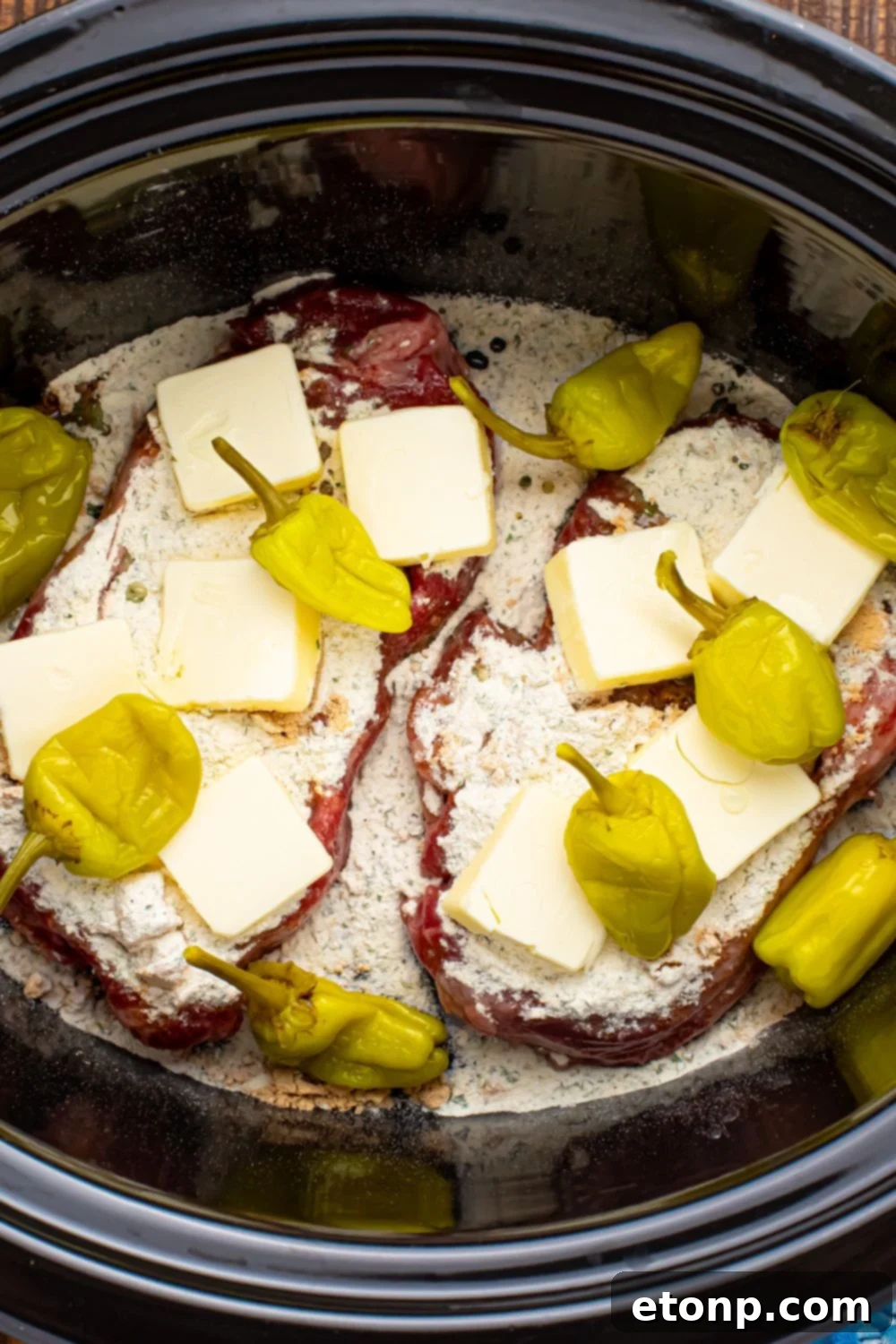 peppers and buter over Slow Cooker Mississippi Ribeye Steaks