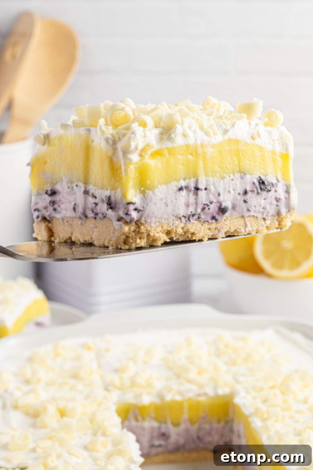 Lemon Blueberry Dream 19 piece of lush being lifed out of the pan