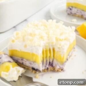 Lemon Blueberry Dream 24 Lemon Blueberry Lush sliced on plate with a fork with a bite on it