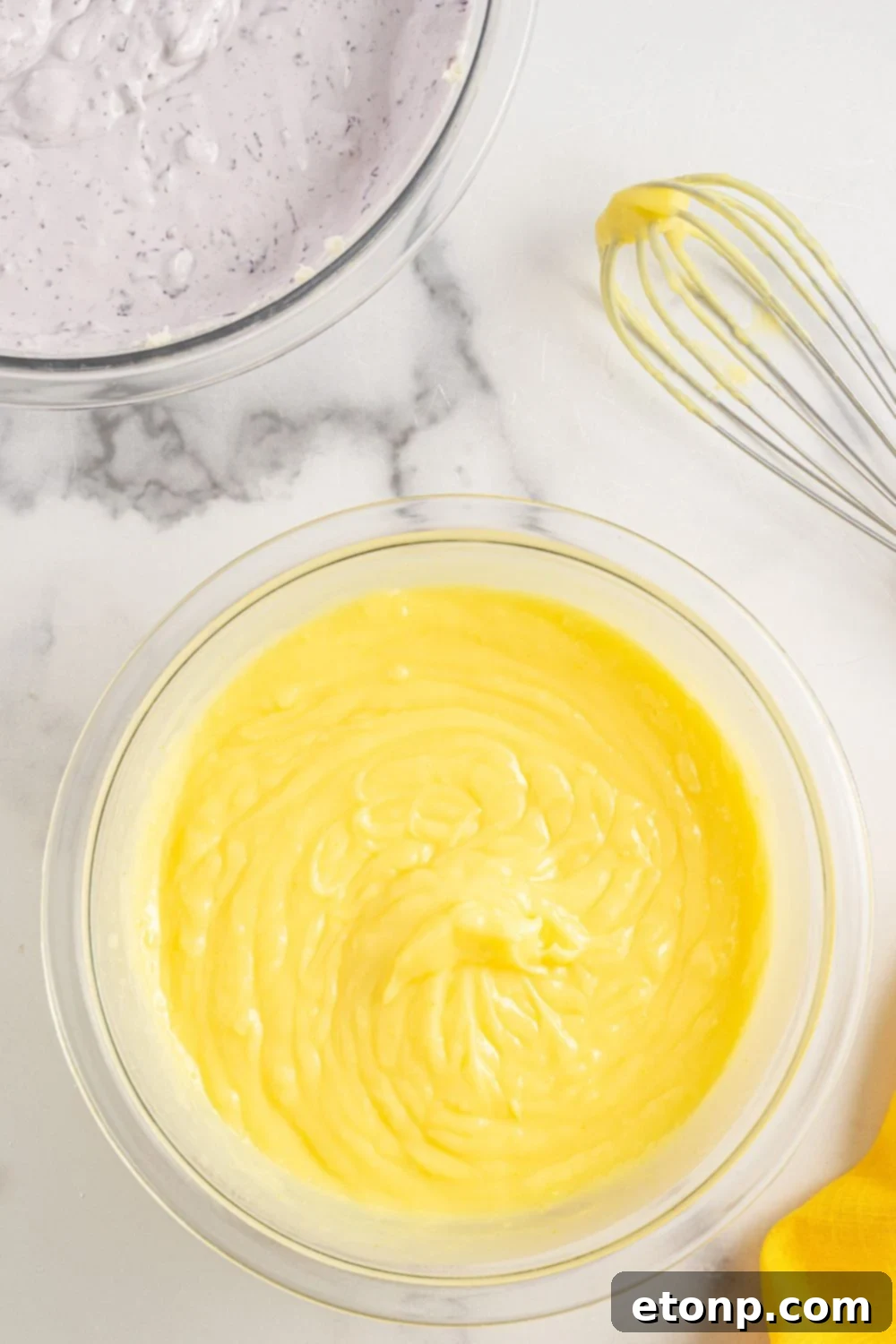 Lemon Blueberry Dream 10 lemon pudding layer mixed up in a bowl on marble table for Lemon Blueberry Lush