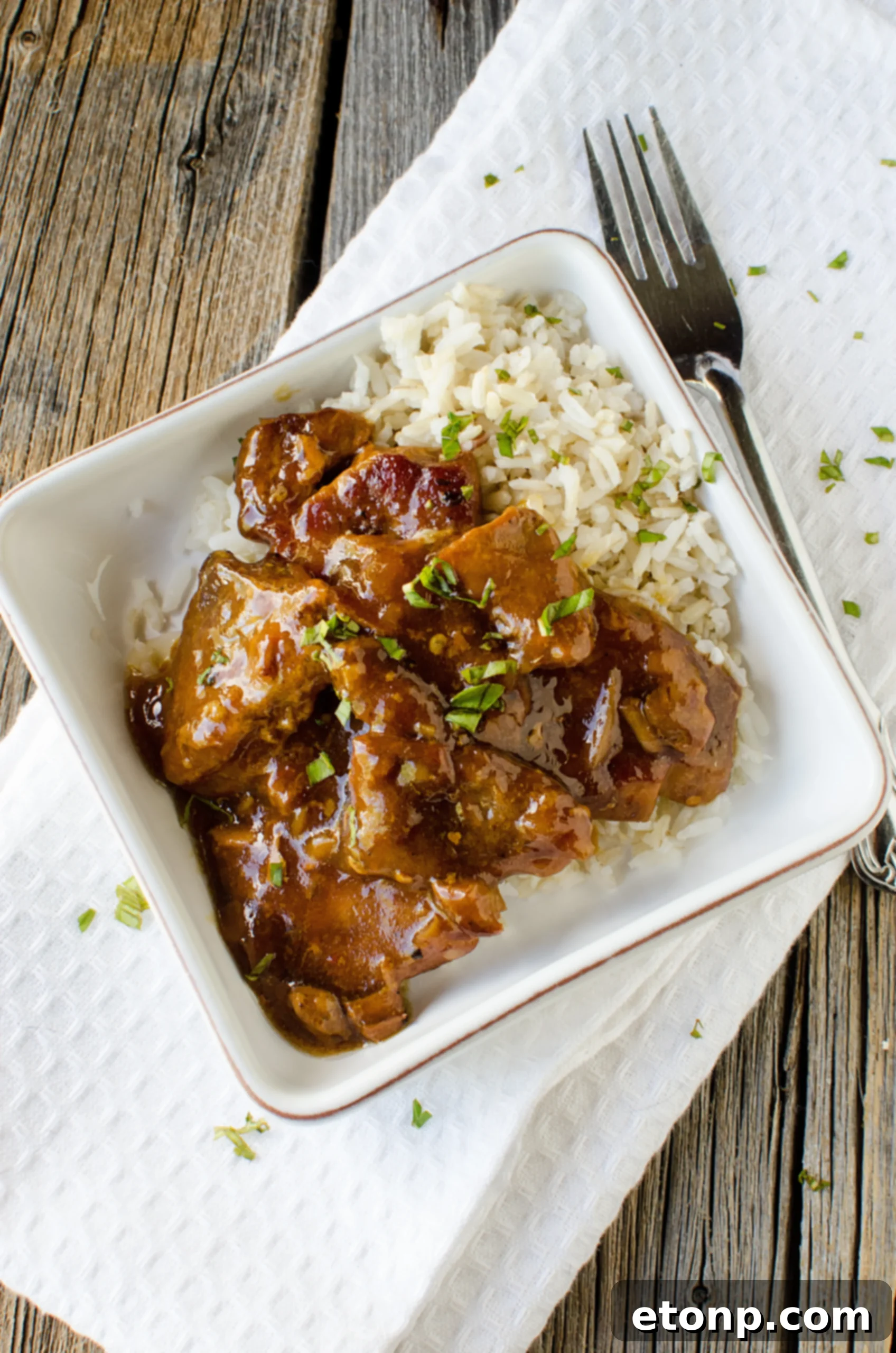 A full serving of Slow Cooker Garlic Ginger Pork with rice, ready to be enjoyed