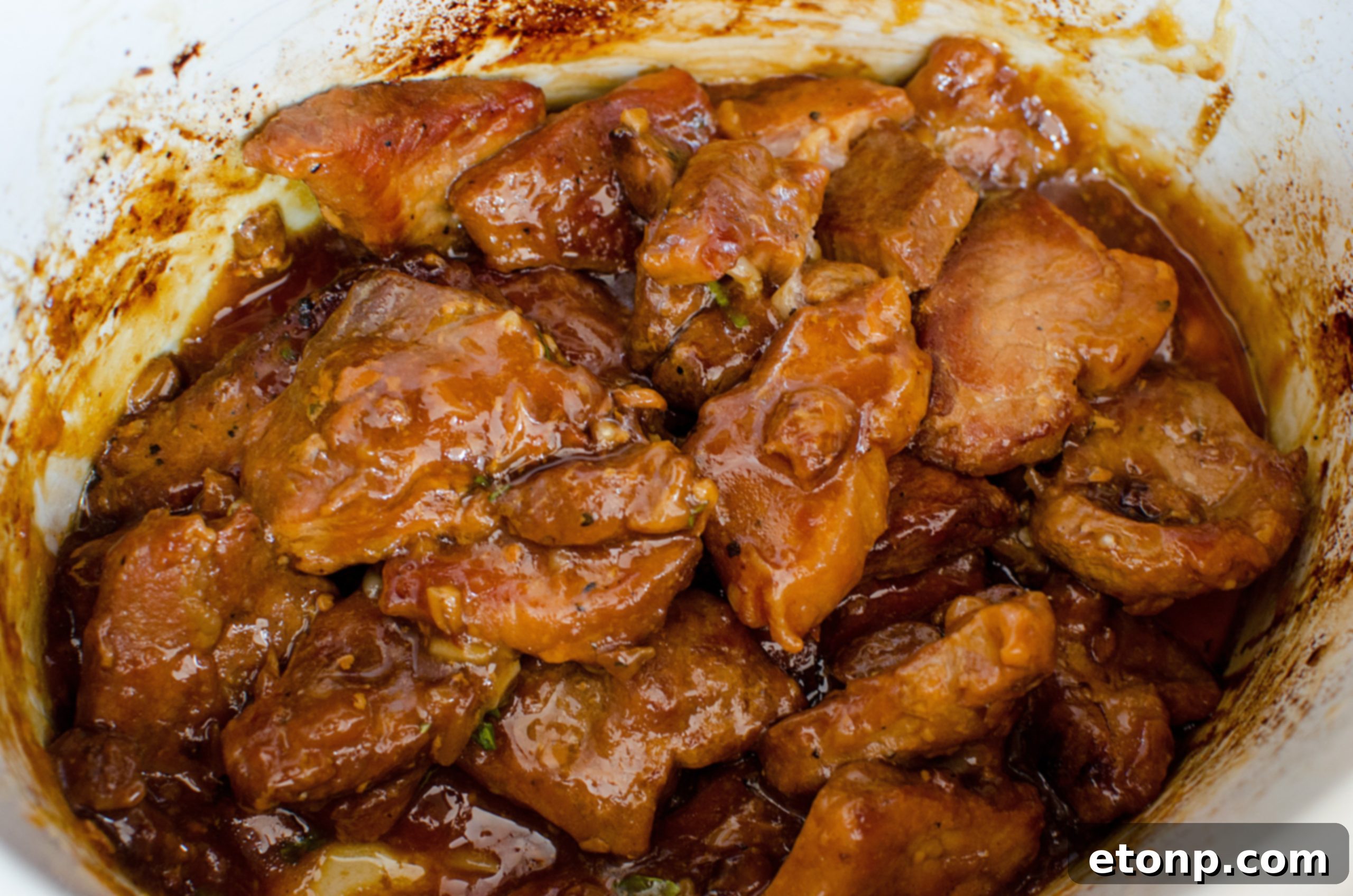 Slow Cooker Garlic Ginger Pork glistening with sauce, close-up
