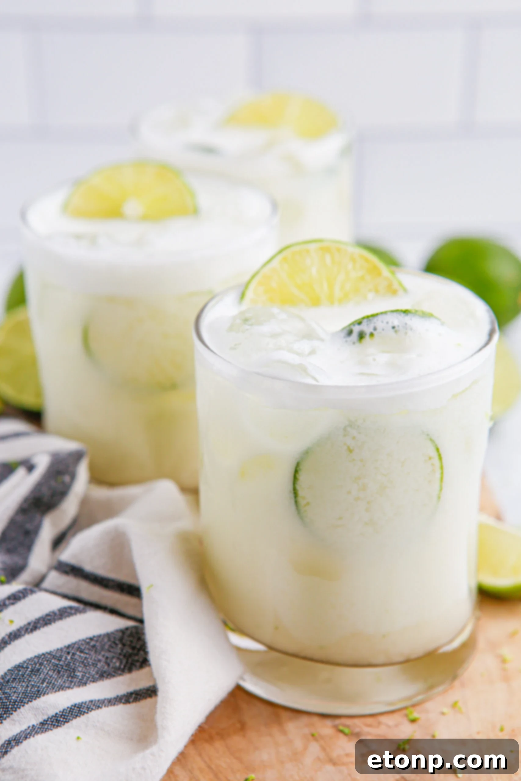 Brazilian Lemonade in clear glasses with sliced limes on top