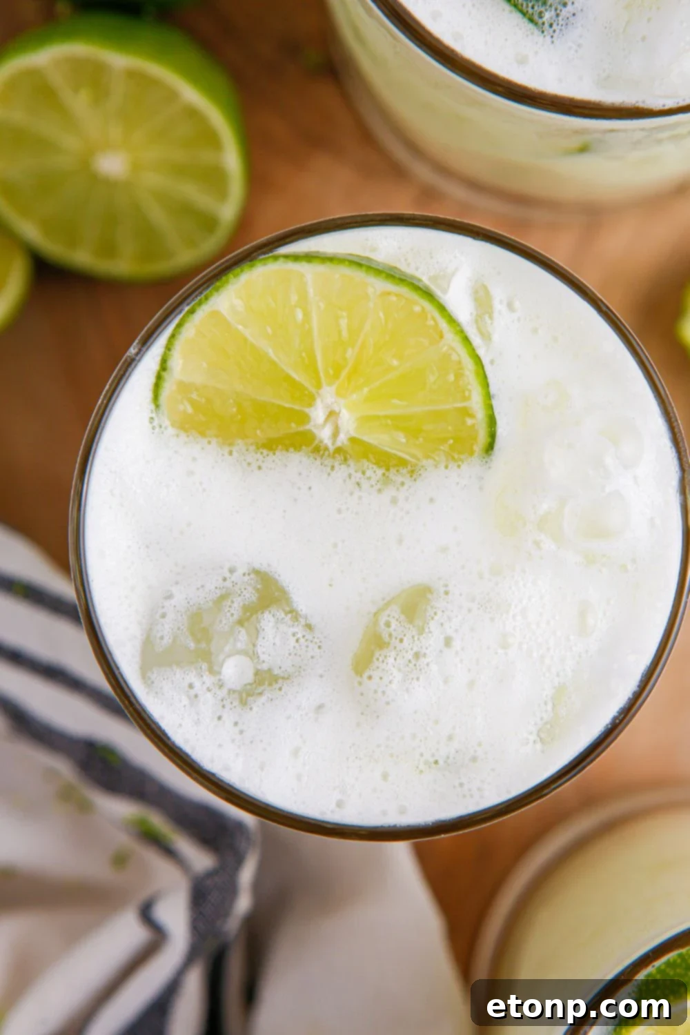 Brazilian Limeade in glass with overhead look to see the white creamy texture and a lime garnish