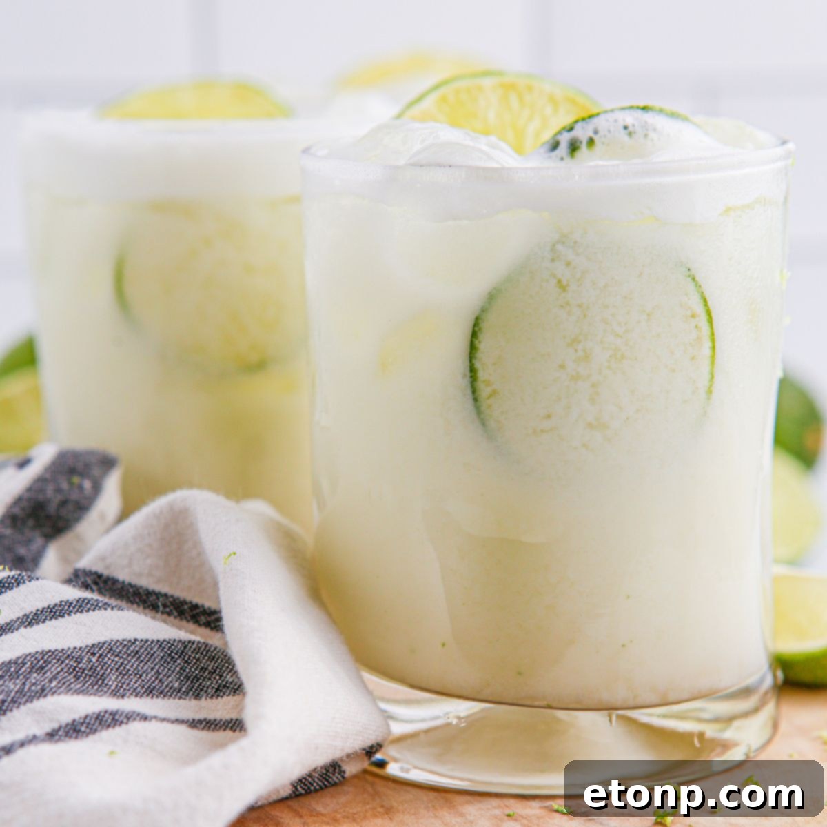 Brazilian Limeades in glasses on table with a towel around it 