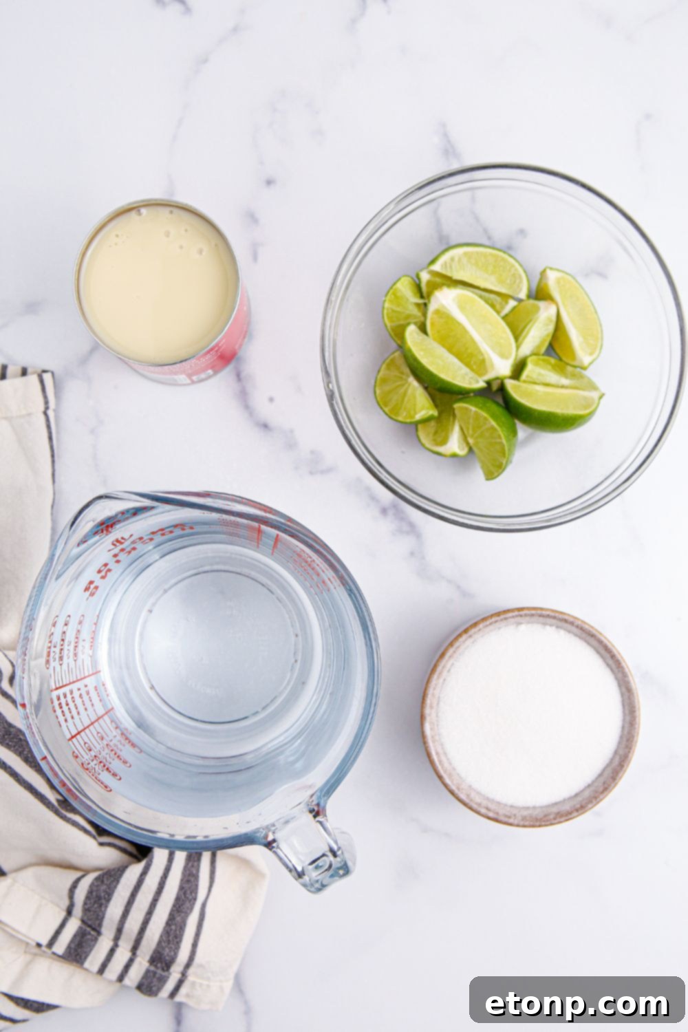 ingredients for Brazilian Limeade sitting on marble counter 