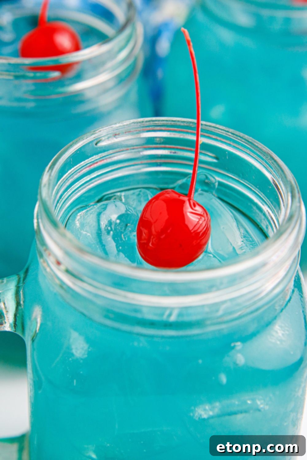 Blue Hawaiian Punch in glasses with a stemmed cherry