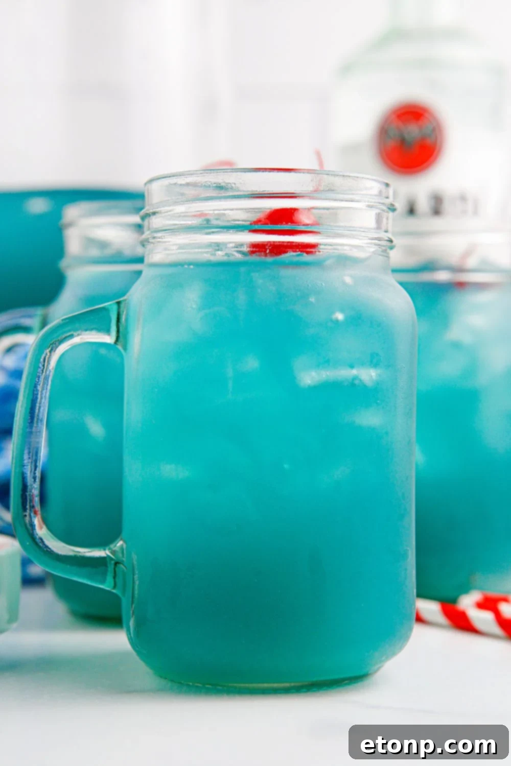 Side of glass on table with Blue Hawaiian Punch in it