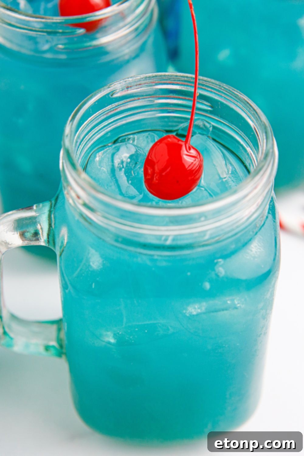 Blue hurricane drink in glasses sitting on table