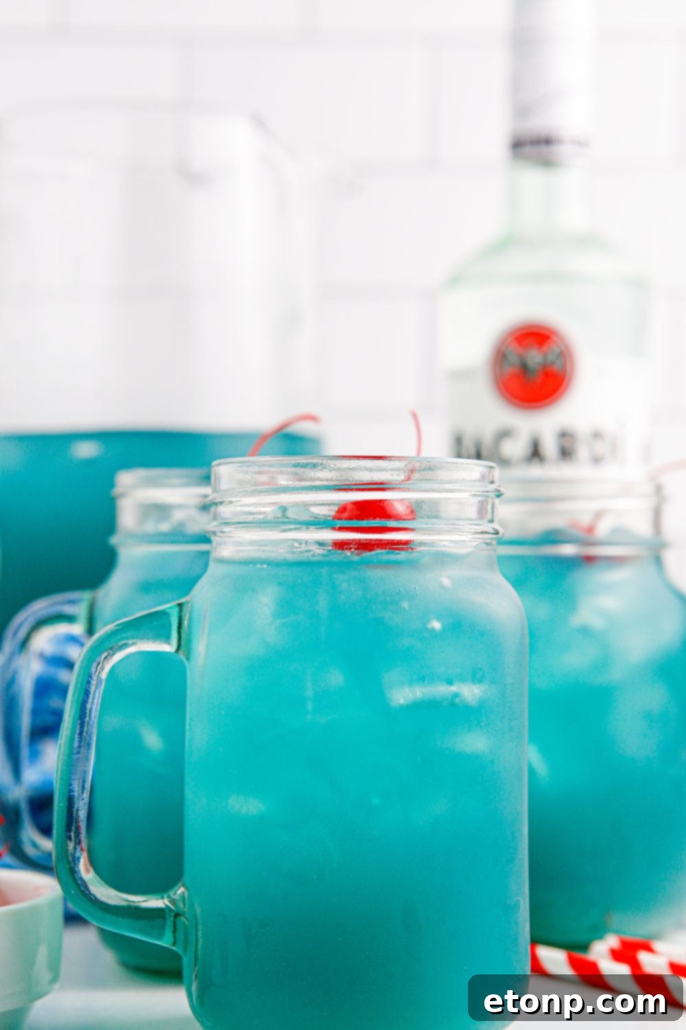 Blue Hawaiian Punch in glasses and a pitcher sitting on table