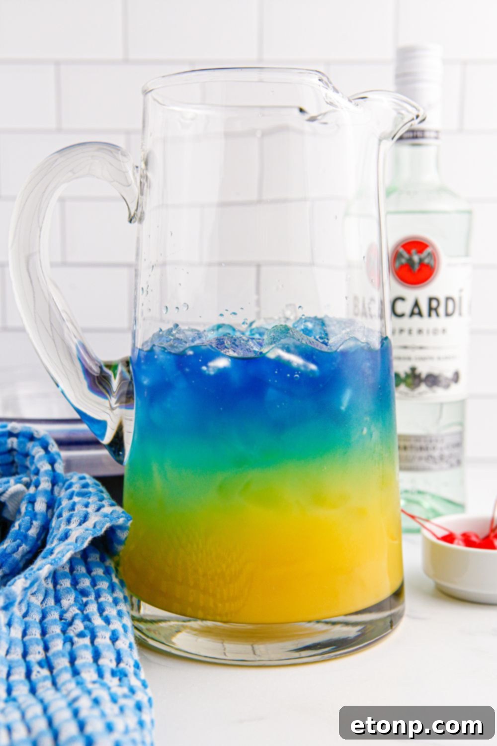 Blue Hawaiian Punch being layered into a pitcher on the table