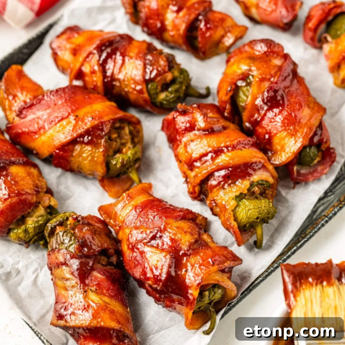 Texas Twinkies arranged on a baking sheet with a BBQ brush on the side, ready to be served