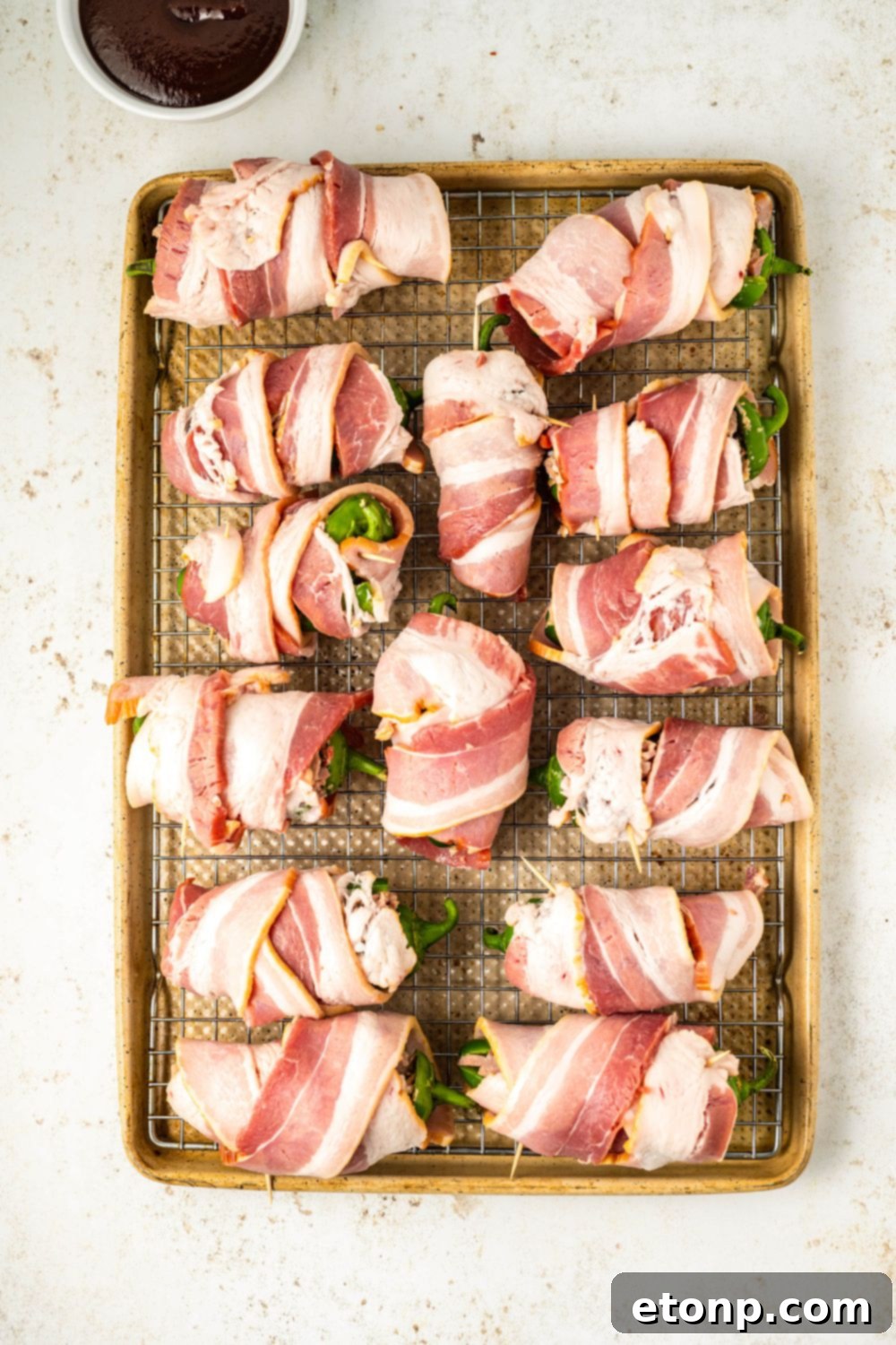 Assembled Texas Twinkies evenly spaced on a cookie sheet, ready for the oven or smoker