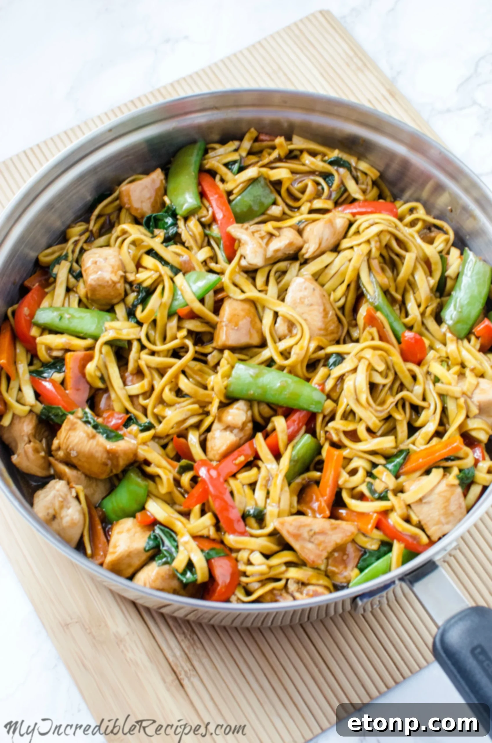 A bowl of freshly made chicken lo mein with chopsticks