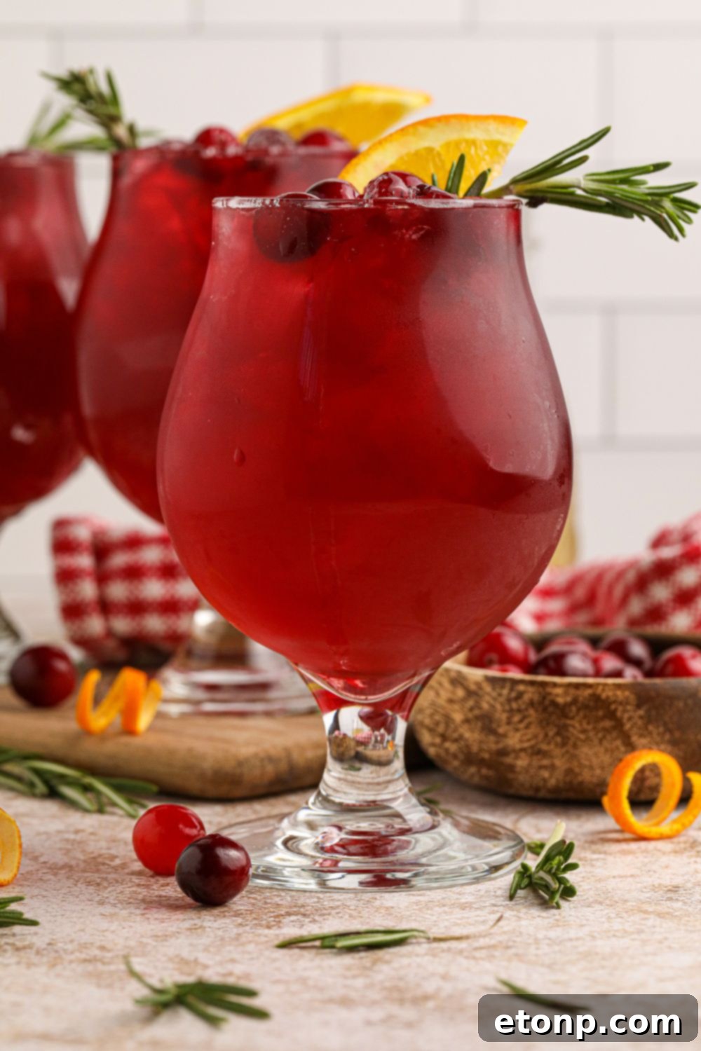 Close-up of cranberry ginger whiskey sour cocktails on table in glasses with natural lighting