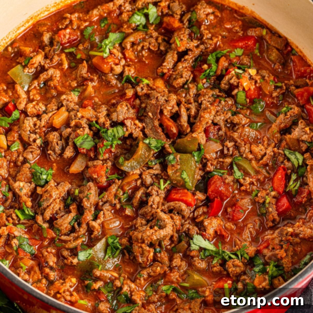 Ground Beef 3 Carne Picada in a Dutch oven showcases all the simmered beef and vegetables