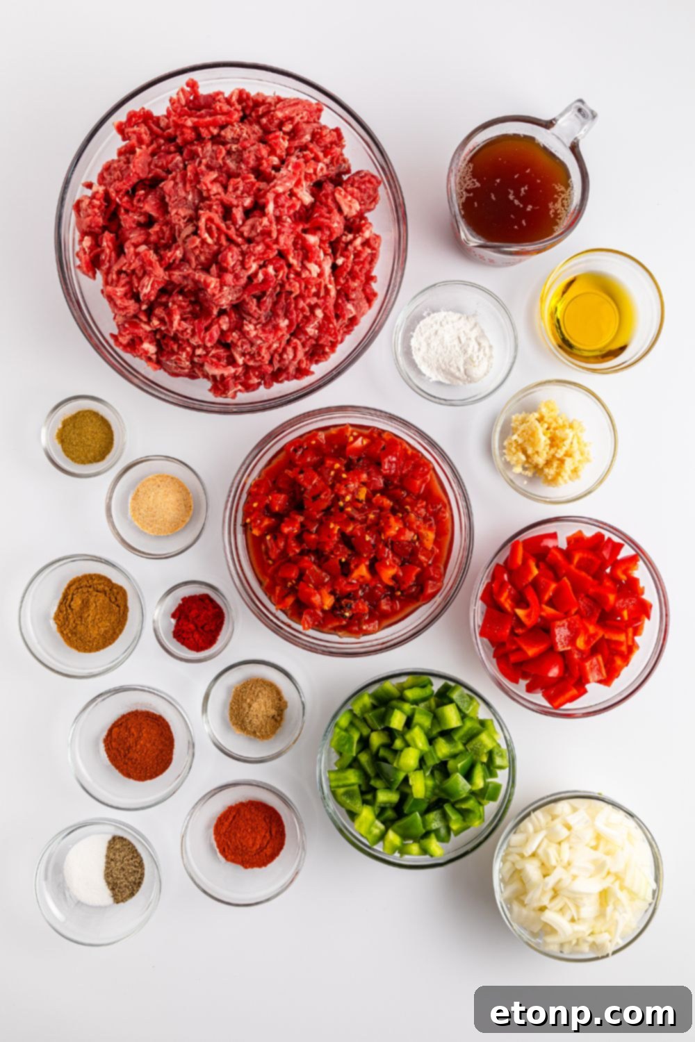 Ground Beef 5 ingredients of carne picada in small bowls on table to showcase each ingredients