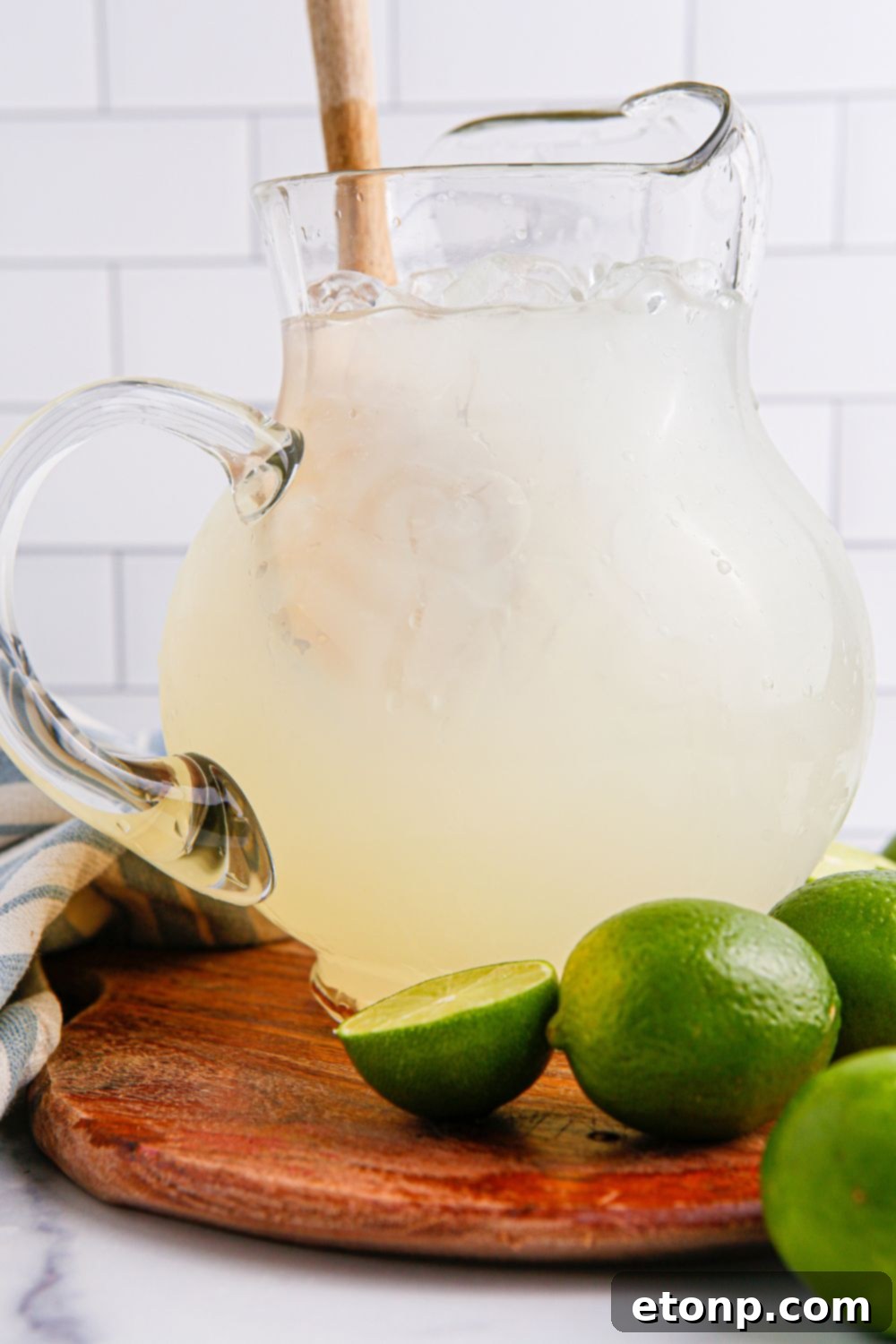 pitcher with limeade in it and a wooden spoon in pitcher 