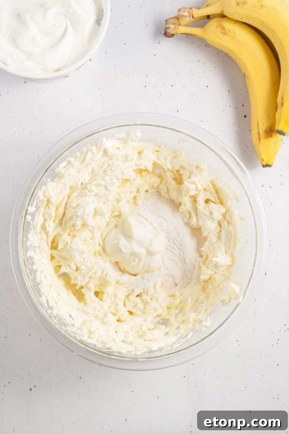 Dreamy No Bake Banana Pudding Cheesecake 9 Cream cheese and pudding mixture blending in a bowl, forming the cheesecake filling base.