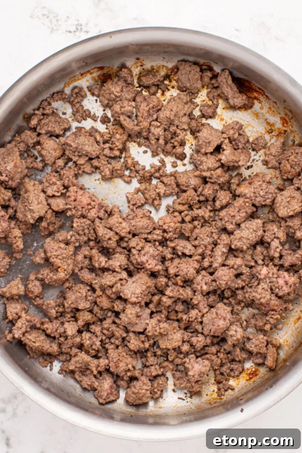 cooked ground beef in a skillet 