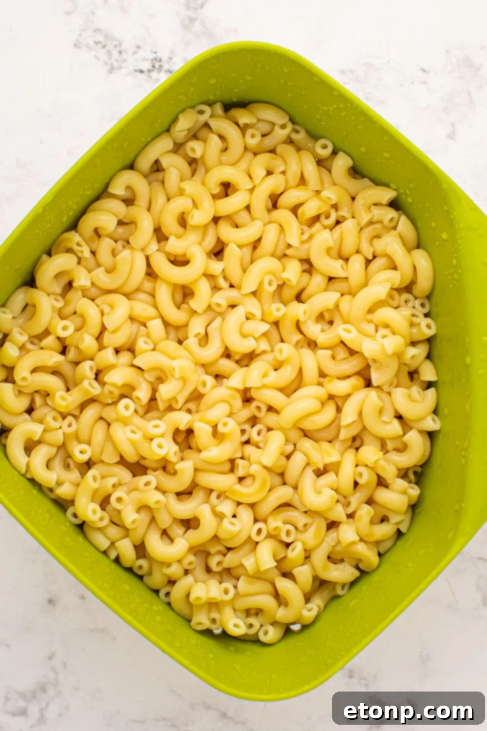 cooked macaroni in a strainer 
