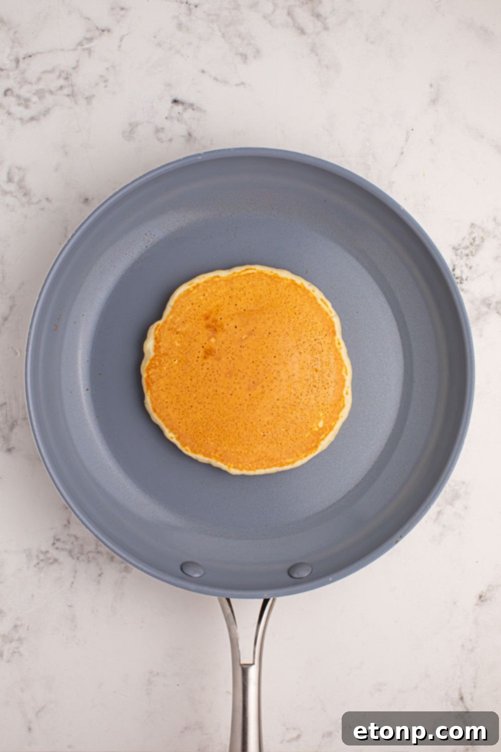 A perfectly cooked pancake in the center of a skillet