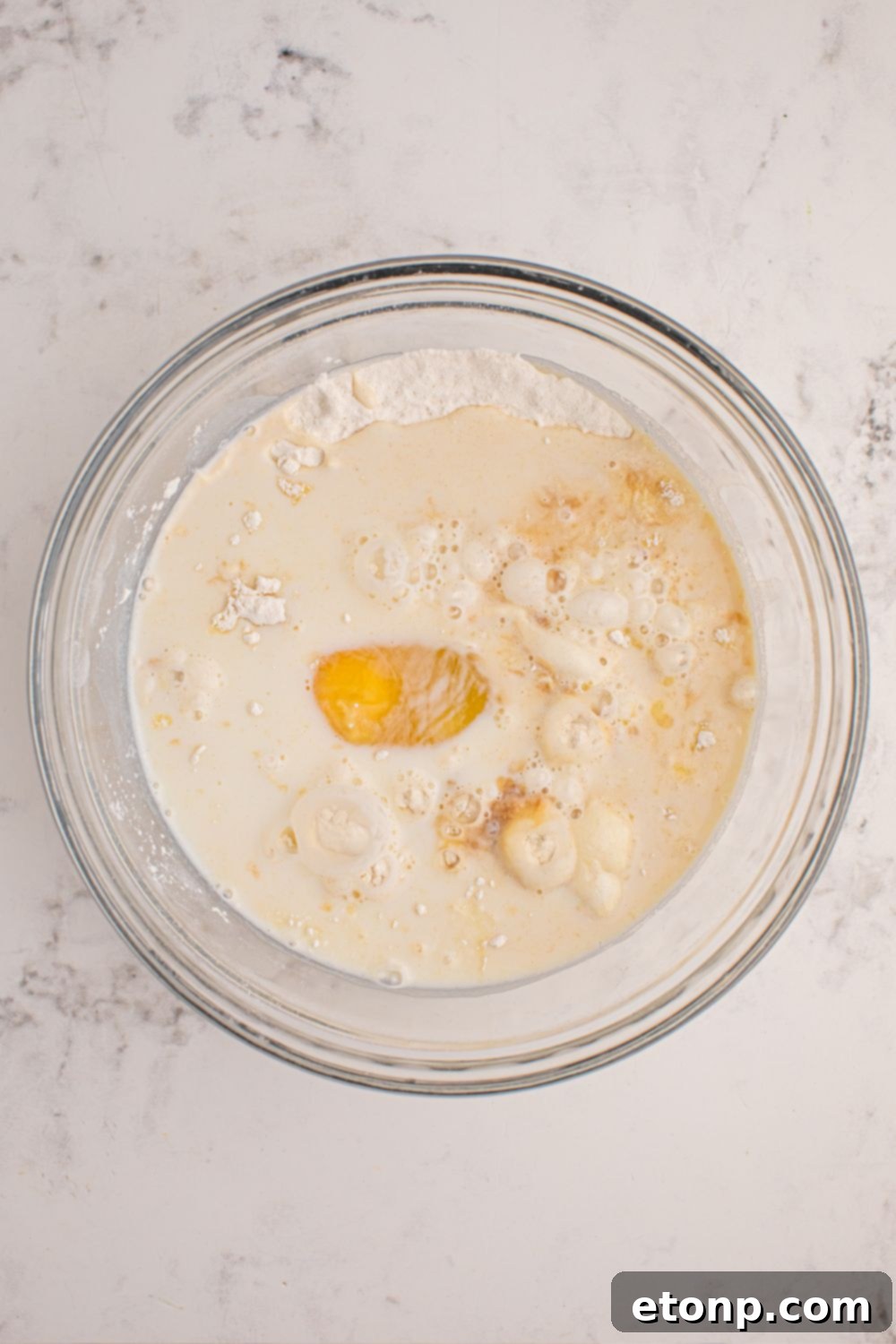 Pancake batter in a glass mixing bowl