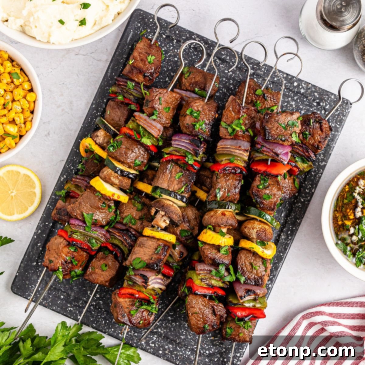 Marinated Beef Kabobs on a platter sitting on table 