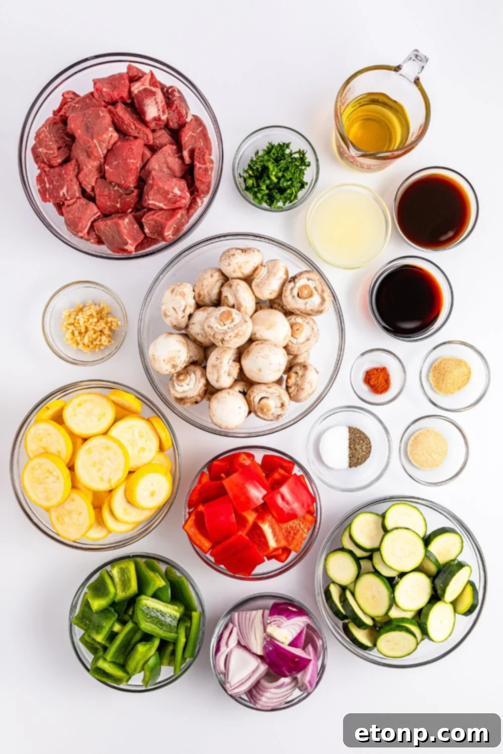 all the ingredients to make these Marinated Beef Kabobs sitting in glass bowls on a counter