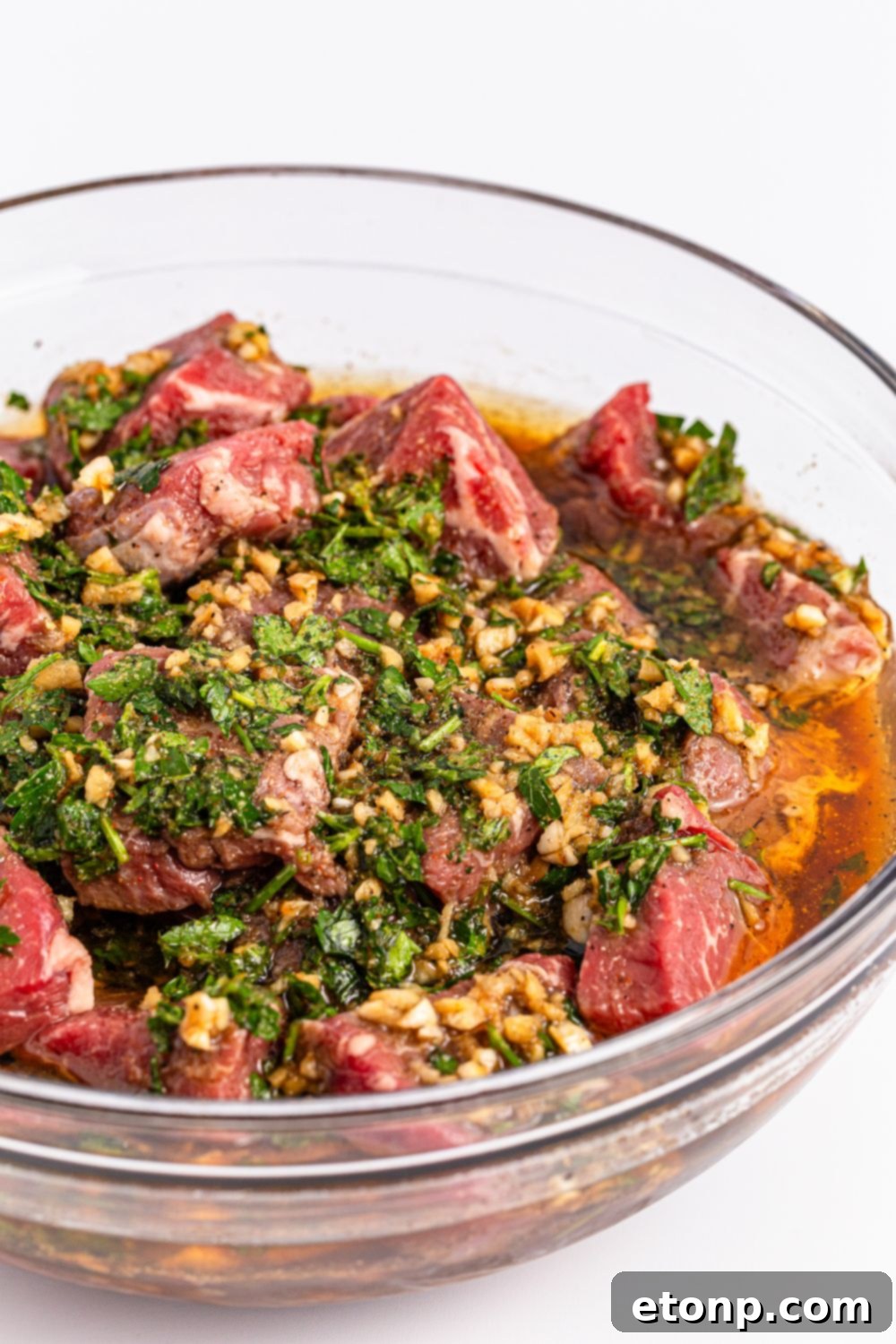 steak in a homemade marinade in a bowl sitting on counter 