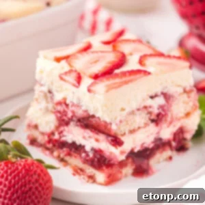 Strawberry Tiramisu on a white plate, showcasing its beautiful layers.