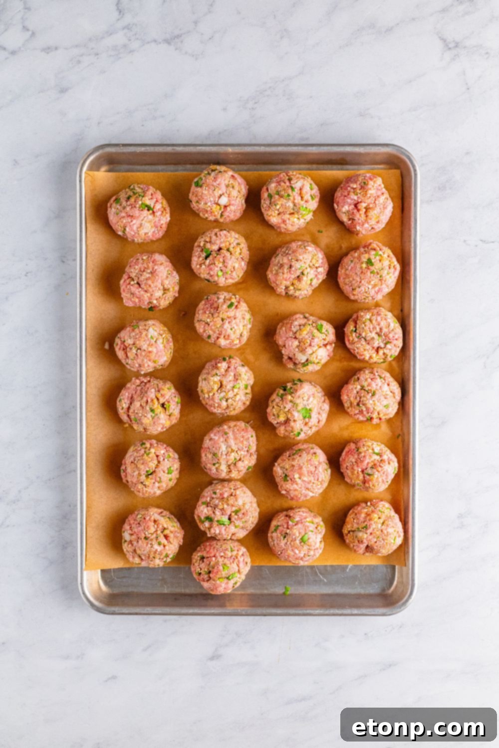 raw Classic Italian Meatballs on a baking tray 