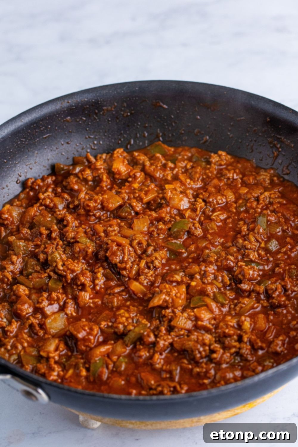 The fully mixed Dr. Pepper Sloppy Joes sauce simmering in a skillet, rich and thick, ready to be served.