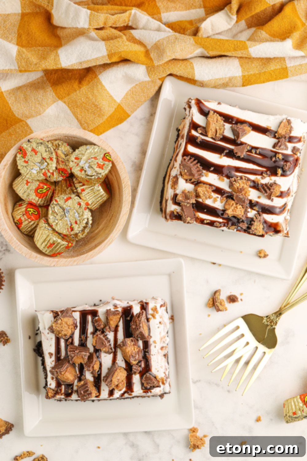 Reese's Peanut Butter Bliss Stack 21 A beautifully set table featuring individual slices of Reese's Lasagna on plates, surrounded by bowls of candies and forks, inviting guests to indulge.
