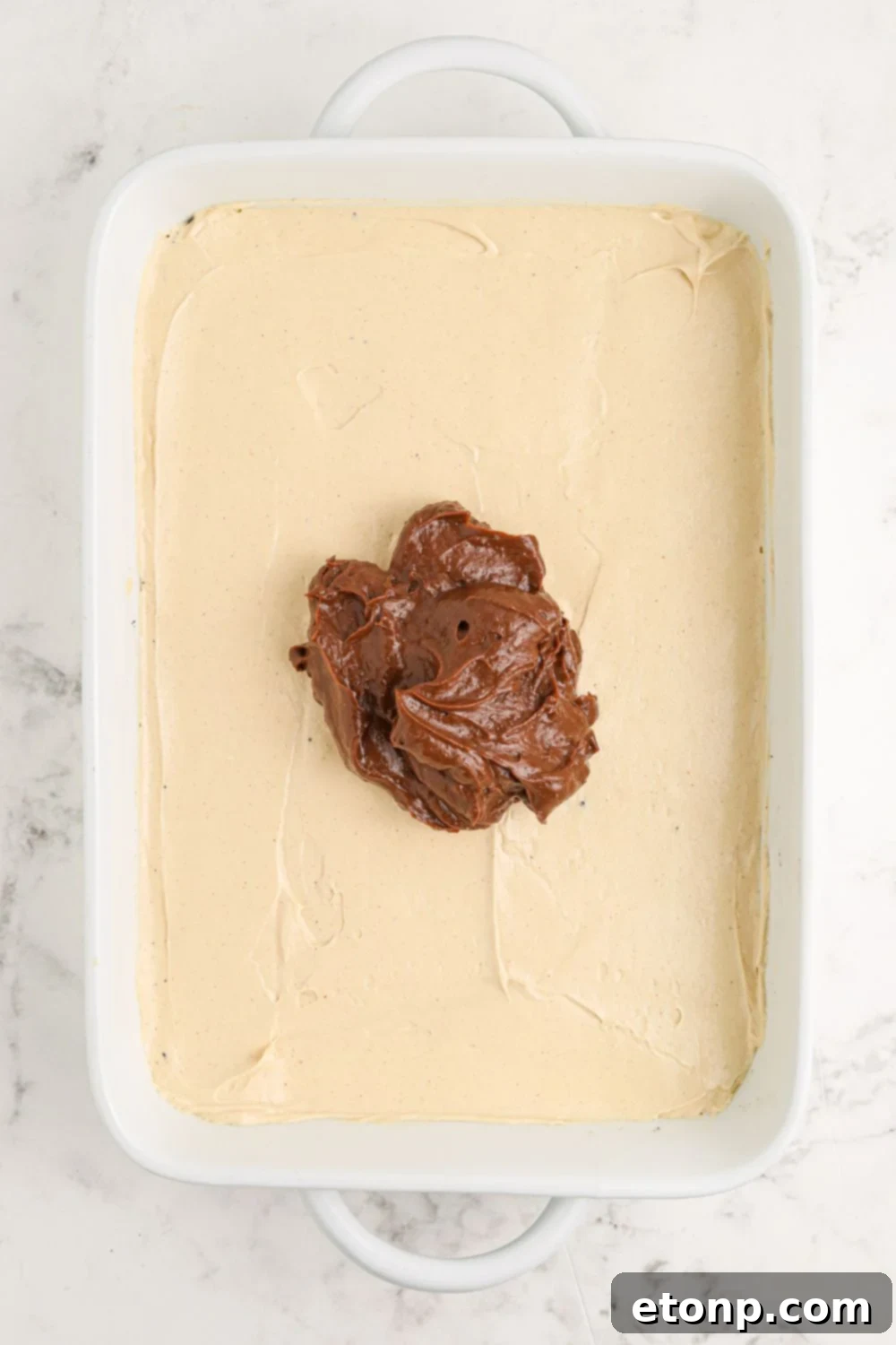 Reese's Peanut Butter Bliss Stack 10 The Reese's Lasagna taking shape with the peanut butter cream cheese layer smoothly spread, followed by a generous dollop of chocolate pudding in the center.