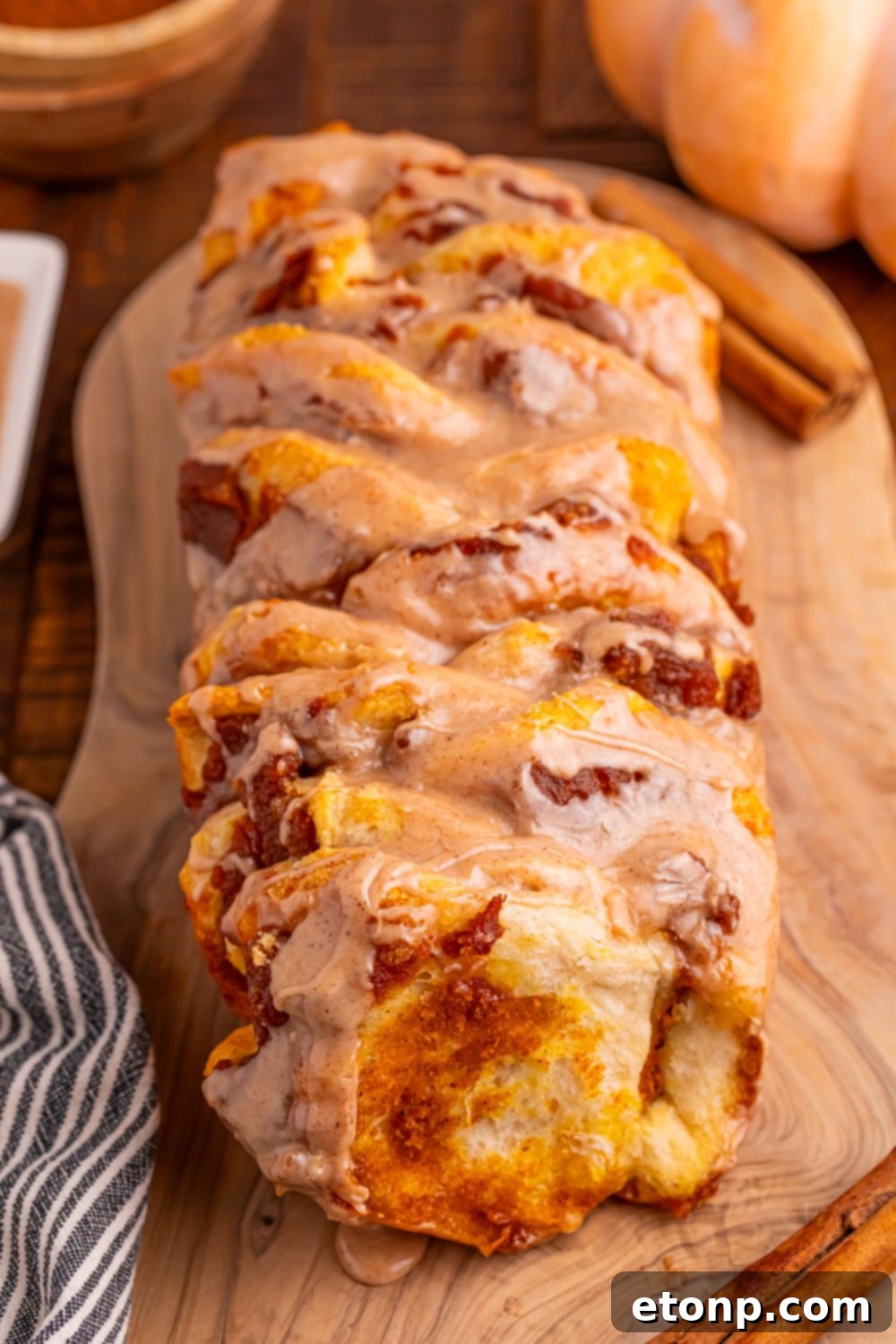 Golden Pumpkin Blossom Bread 14 Pumpkin Pie Pull Apart Bread on table with pumpkin on table and cinnamon stick on table