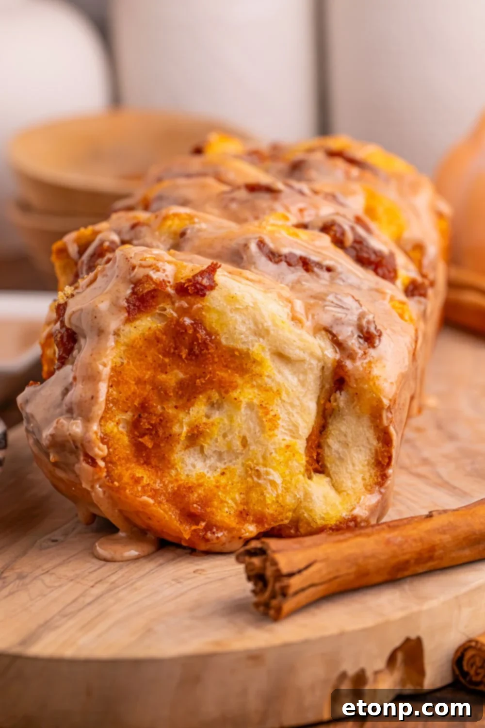 Golden Pumpkin Blossom Bread 4 Pumpkin Pie Pull Apart Bread on table with a cinnamon stick sitting by it on the cutting board