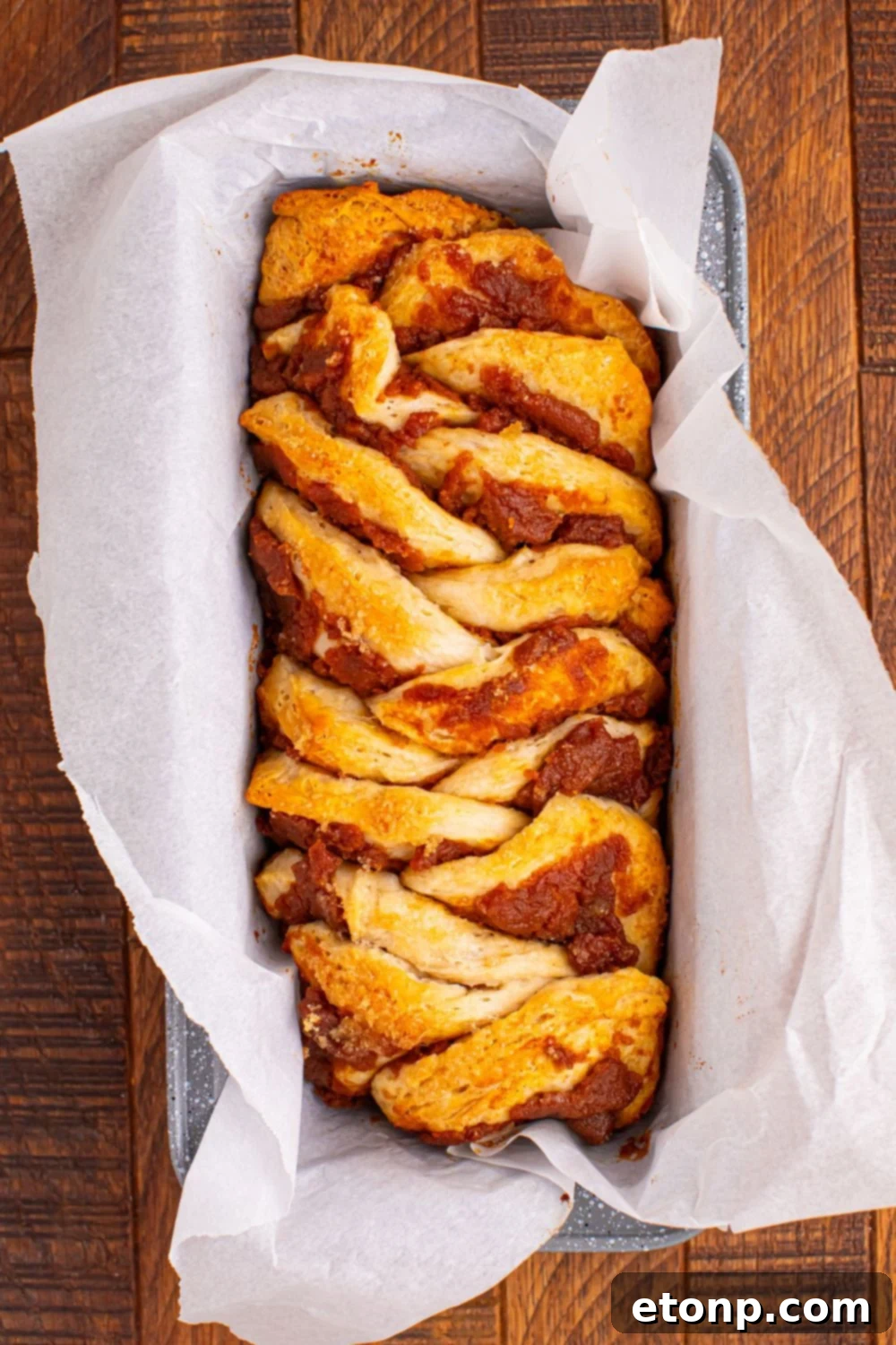 Golden Pumpkin Blossom Bread 10 Pumpkin Pie Pull Apart Bread baked in a loaf pan with parchment paper in it
