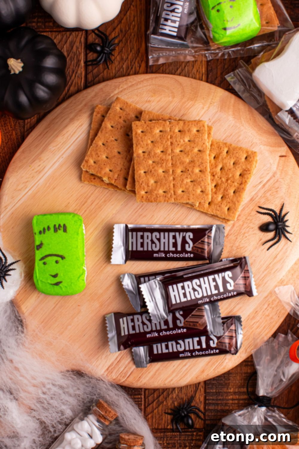 Spooky Smores Treat Packs 5 ingredients for Halloween Smores Gift Bags on table with Halloween decor items around it on table