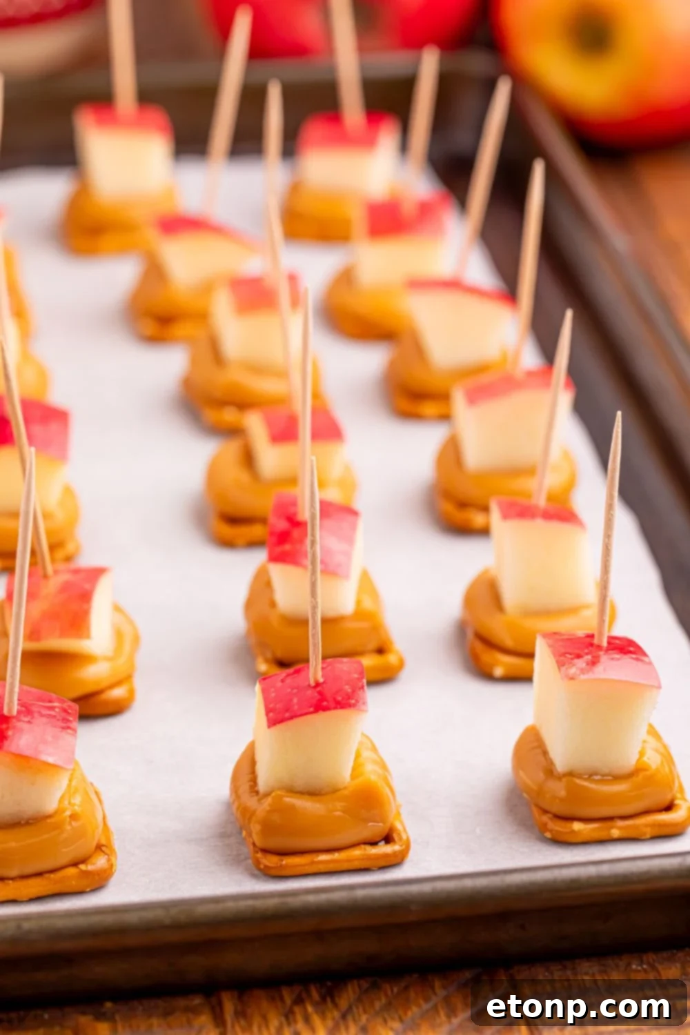 Sweet and Salty Caramel Apple Pretzel Bites 16 Caramel Apple Pretzel Bites on a baking sheet sitting on table