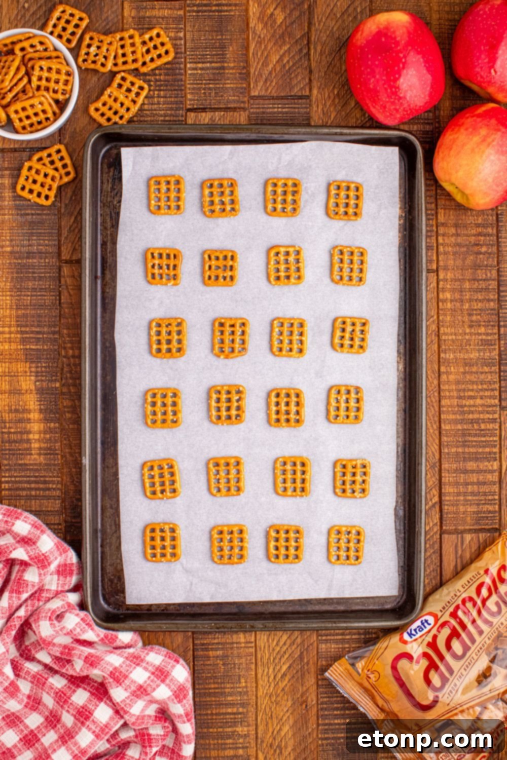 Sweet and Salty Caramel Apple Pretzel Bites 6 pretzel squares spread out on cooking tray