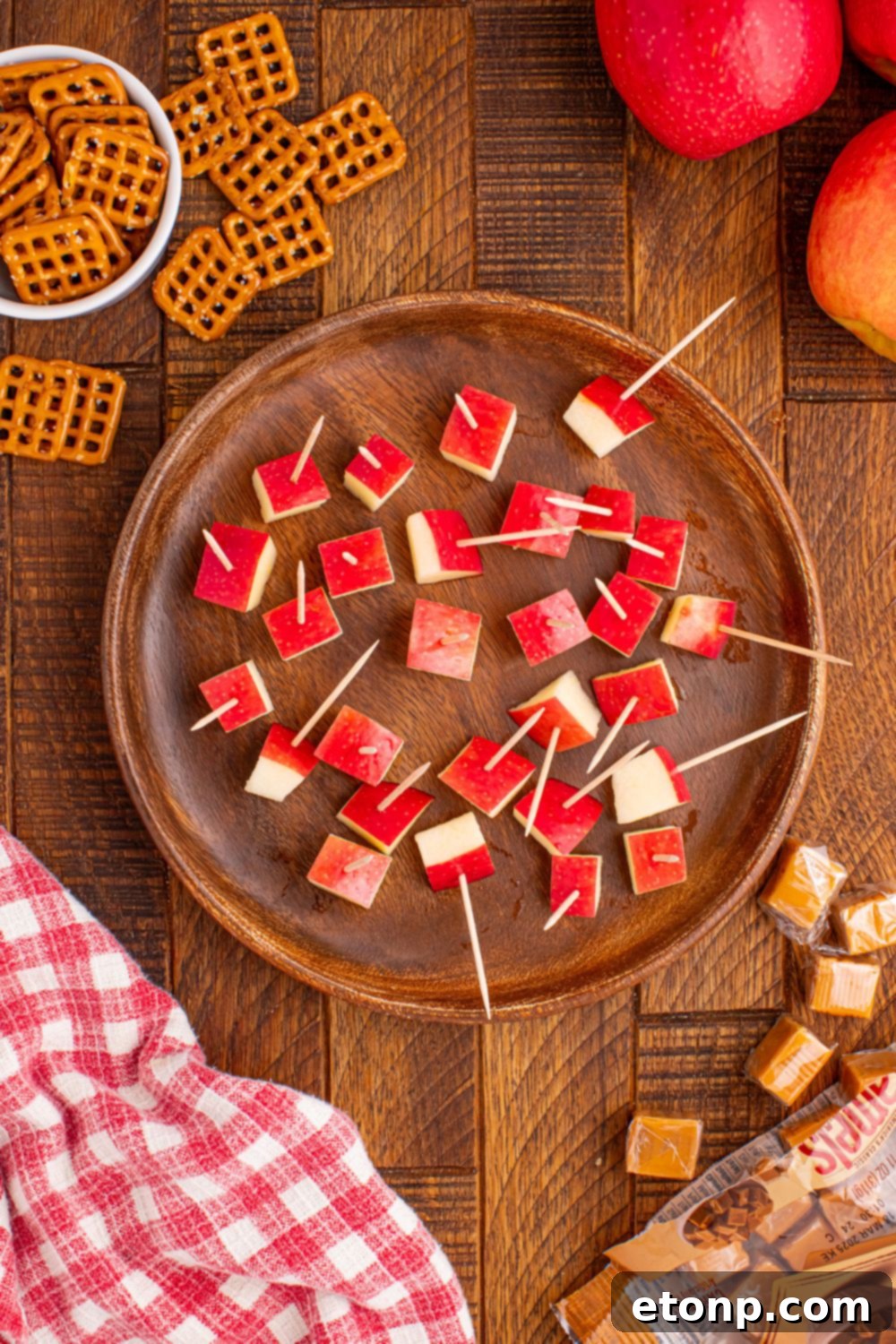 Sweet and Salty Caramel Apple Pretzel Bites 8 diced apples with pretzels in them sitting in a bowl on table