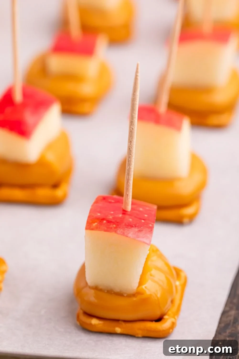 Sweet and Salty Caramel Apple Pretzel Bites 10 close up of caramel apple pretzel bites on cookie tray