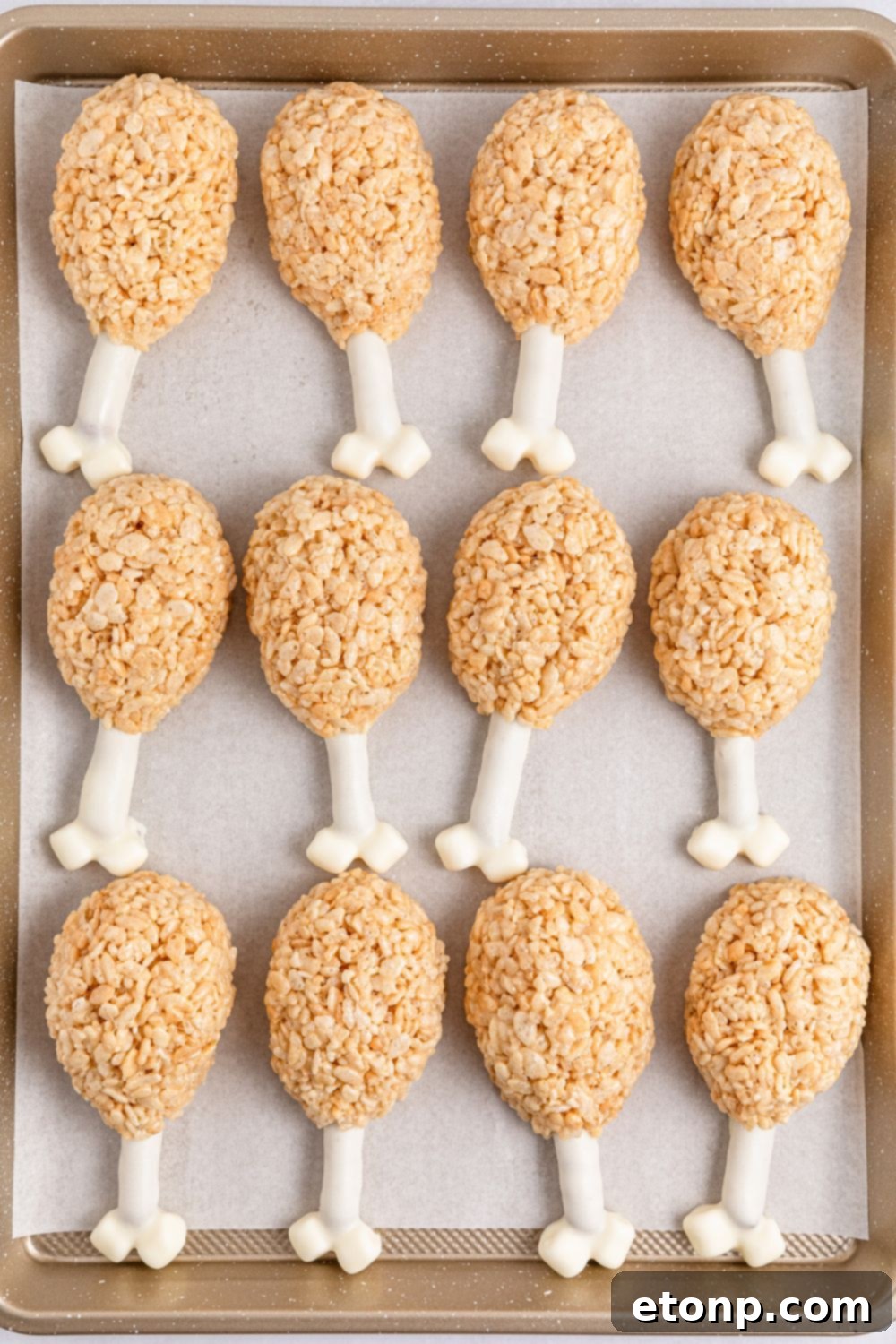 overhead look of Rice Krispie Treat Turkey Legs on a baking tray spread out 