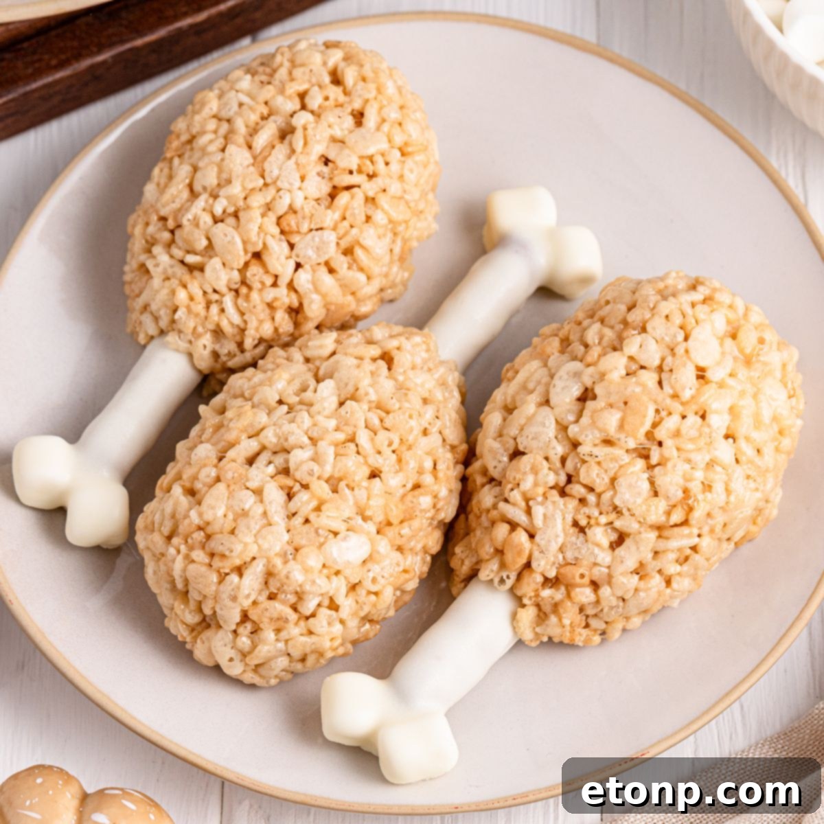 Rice Krispie Treat Turkey Legs on a white plate sitting on table 